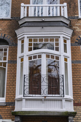 Close-up view details of colorful building with gable rooftop and hook along Prinsengracht canal in Amsterdam. Prinsengracht (Prince's Canal) named after Prince of Orange. Amsterdam, the Netherlands.