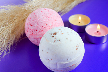 bath bomb and arom candles on colorful background. Spa set, body care, background.
