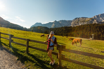 woman enjoying beauty of nature looking at mountain. Adventure travel, Europe. Woman stands on background with Alps.