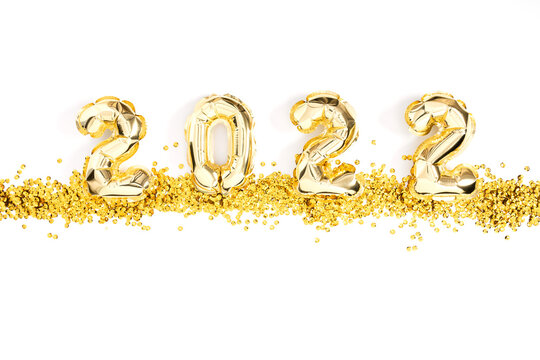 Happy New Year 2022. Foil gold balloons in form of numbers 2022. New year celebration. Gold Air Balloons on white background. Flat lay, top view, copy space