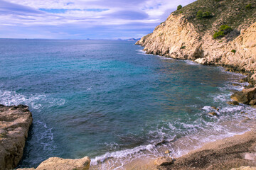 a beautiful coastline, beach, coves and cliffs in Villajoyosa, Alicante, Spain. Walking for the...