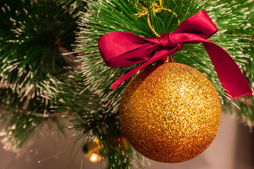 selective focus of yellow golden ball and red loop ornate on the christmas tree in Brazil