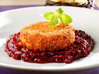 Camembert cheese in a crust with red fruit jam
