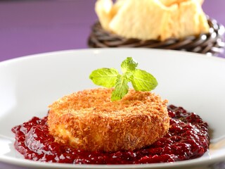 Camembert cheese in a crust with red fruit jam