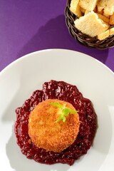Camembert cheese in a crust with red fruit jam