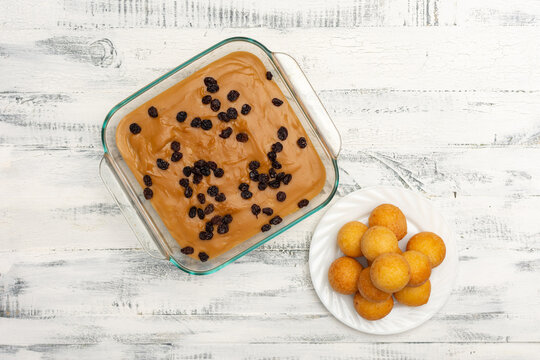 Top of view of natilla and bu&ntilde;uelos traditional christmas food in Colombia over old white background. Traditional christmas food
