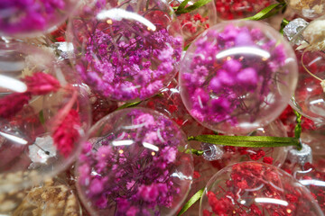 Fototapeta na wymiar Close up of glass balls with dried flowers inside