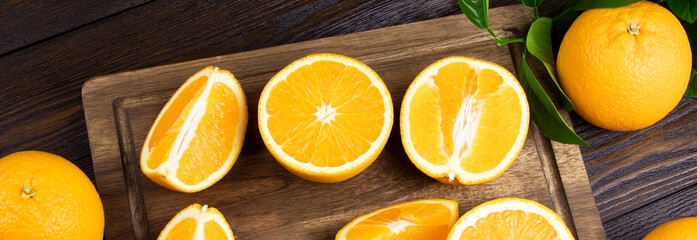 Orange fruits on a wooden background banner. Healthy food. Vitamins and food. Slice of orange. Selected focus
