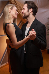 Male dancing with his girlfriend and smiling at her