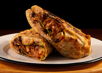 Burrito with meat on a white plate