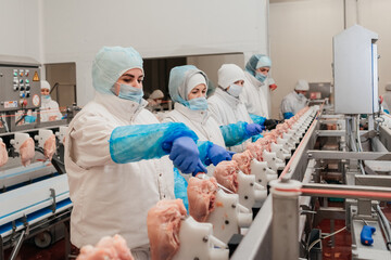 Meat processing equipment.Automated production line with packaging and cutting of meat in modern food factory.