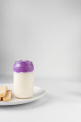 Ube whipped cream and milk, ube latte, purple latte, violet whipped cream, purple potato latte with savoiardi cookies