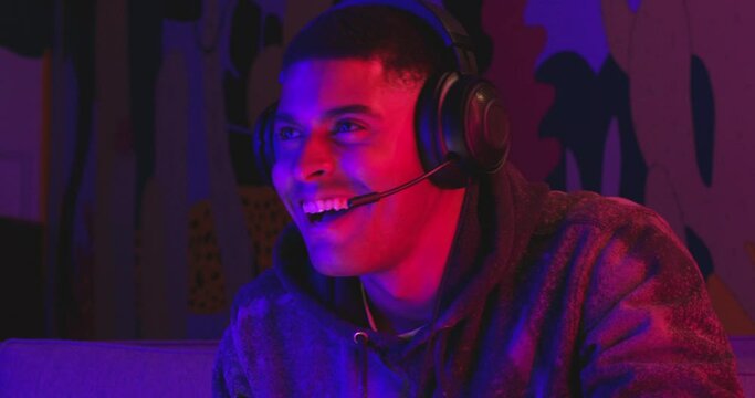 Man smiles while winning video game