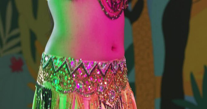 Tight shot of woman belly dancing
