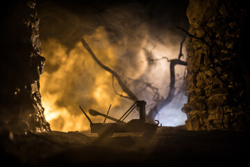 ancient catapult on a background the wall of fortress. Selective focus