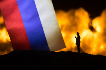 Turkey small flag on burning dark background. Concept of crisis of war and political conflicts...