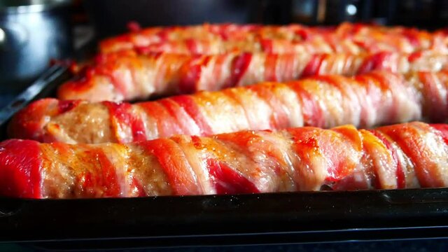 Extra large foot long pigs in blankets traditional bacon wrapped British Christmas homemade party food sliding right shot