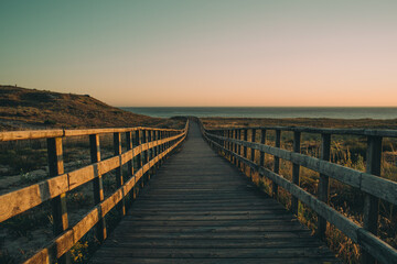 Fototapeta na wymiar wooden bridge at sunset