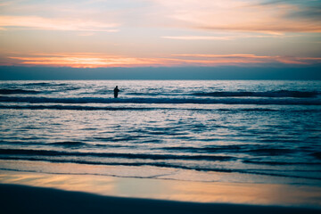 Fototapeta na wymiar silhouette of a person on the beach