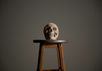 human skull on a stool