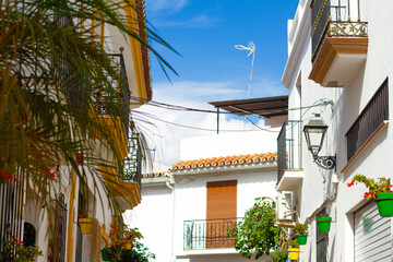 A typical street in old city Estepona with colorful flower pots. Estepona, Andalusia, Spain