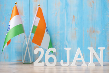 Wooden text of January 26th with miniature India flags. India republic Day and happy celebration...