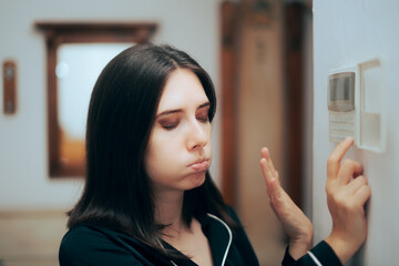 Woman Feeling Hot Setting the Room Temperature to be Lower