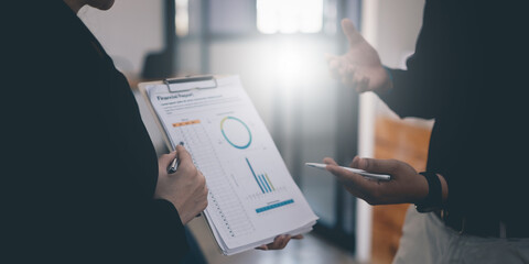 Business People Meeting to discuss and brainstorming the financial report paperwork in home office. Financial advisor teamwork and accounting concept.