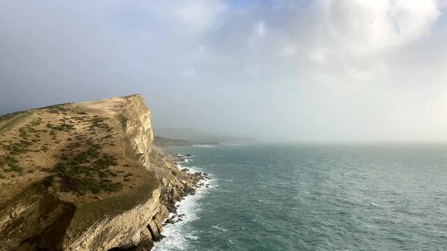 Beautiful shot of a cliff edge and the ocean on the Jurassic Coast, England