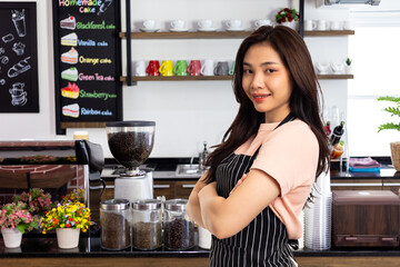 Portrait of confident and woman barista standing behind counter. female confidently starting a new business