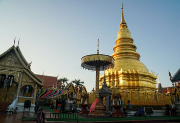 Fototapeta premium Thailand - November 29 2021: golden Haripunchai Pagoda in temple, the famous destination and tourist attraction in the North of Thailand