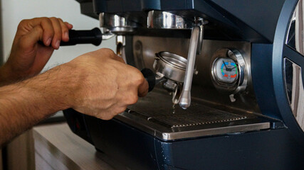 Male hands preparing coffee machine