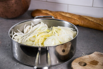 Fresh chopped onions frying in oil in a saucepan