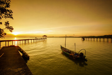 Fototapeta premium Sunset scenic view at seascape with long pier background 