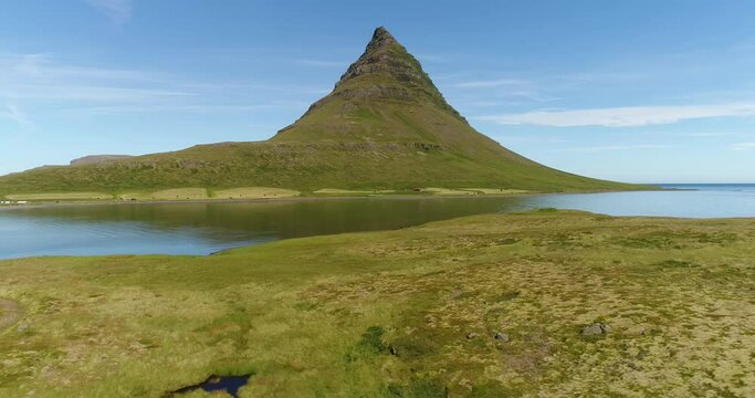 Iceland nature drone video of Kirkjufell mountain landscape. Icon of Iceland and most photographed mountain. West Iceland on the Snaefellsnes peninsula. 4K aerial video