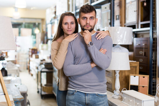 Portrait of attractive girl and her boyfriend in antique furnishings store.