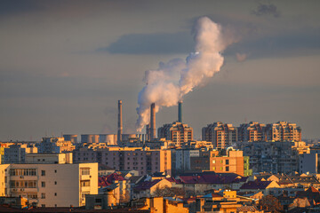 Bucharest from above. Aerial view of its central heating system over the city. The smoke is...