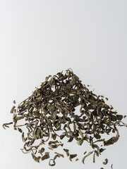 Dry tea leaves isolated on a white background.