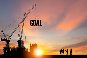 Silhouette of GOAL on construction site with crane and sunset sky for preparation business concepts