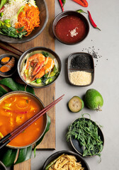 Asian dishes variety on gray background.