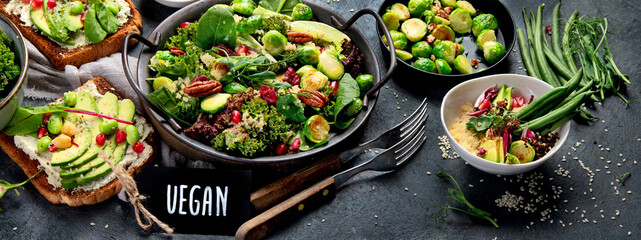 Vegan dishes assortment on gray background.