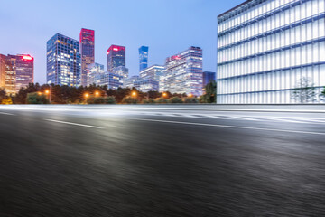 Obraz premium Motion blurred asphalt road and modern commercial building landscape in Beijing, China.