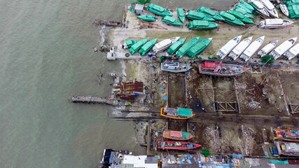 local Shipyard from aerial view with old building and ships on the dock in Na Kluea, Bang la Mung, Chonburi, Thailand