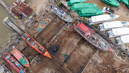 local Shipyard from aerial view with old building and ships on the dock in Na Kluea, Bang la Mung, Chonburi, Thailand - obrazy, fototapety, plakaty