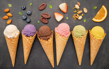 Various of ice cream flavor in cones blueberry ,pistachio ,almond ,orange and chocolate setup on...