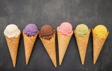 Various of ice cream flavor in cones blueberry ,pistachio ,almond ,orange and chocolate setup on dark stone background . Summer and Sweet menu concept. - 478250853