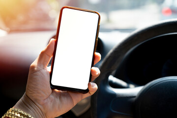 The driver uses the phone while driving. Modern smart phone with round edges.