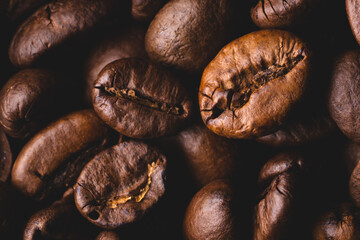 Roasted coffee beans full frame background Close up macro dark brown