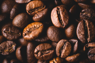 Roasted coffee beans full frame background Close up macro dark brown