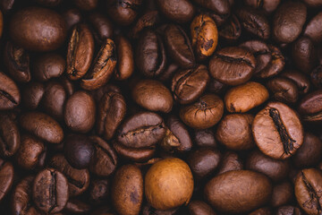 Roasted coffee beans full frame background Close up macro dark brown
